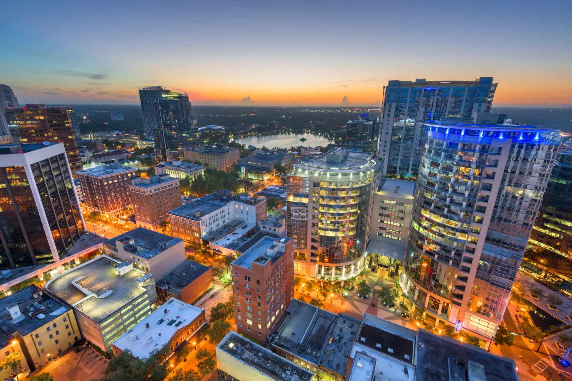 Orlando skyline at sunset featuring modern buildings and city lights, representing urban development and eco-friendly architecture relevant to Eco Panel Systems' WPC wall panels.